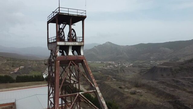 drone ascent to mining tower with mountain landscape in the background
