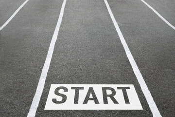 Fototapeta premium the word start on the road with white lines, the concept of the beginning of the path, business, travel