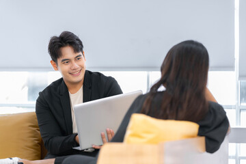 A group of young Asian businessmen Talking and planning work happily and have fun. at the company's office