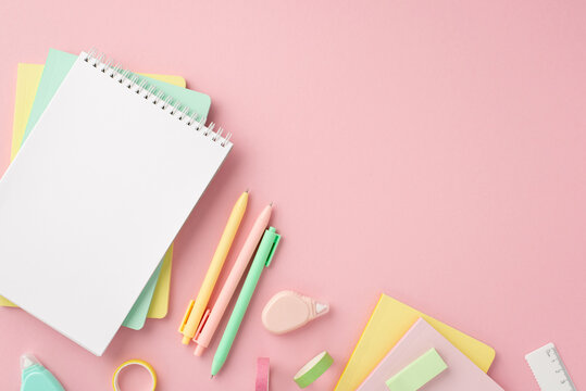 Back to school concept. Top view photo of colorful school supplies notepads pens round correction tape ruler and adhesive tape on isolated pink background with copyspace