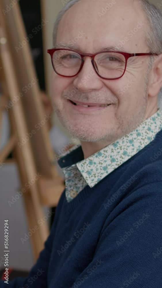 Poster vertical video: portrait of senior man enjoying art class to develop drawing skills for personal gro