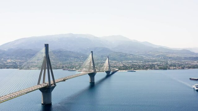 Aerial drone shot of cable strayed bridge over sea also known as Charilaos Trikoupis Rio - Antirio bridge which connects Greece mainland with Peloponnese.