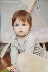 Fototapeta premium baby girl playing with toys in children's room