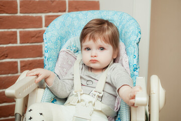 mother feeding baby girl puree by spoon