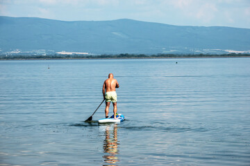 Fototapeta na wymiar Summer sports activity on a paddleboard