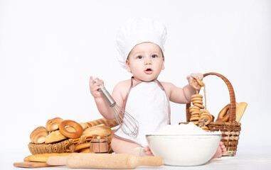 Little boy in a cook cap and with bread funny little chef