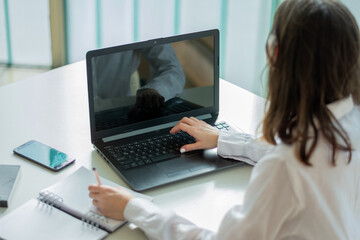 Businesswoman uses her laptop in a co-working office