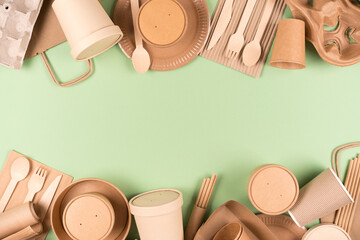 Frame made with eco paper utensils and wooden bamboo cutlery set, food containers and paper cups...