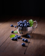 Blueberries with mint in a silver vintage cup 