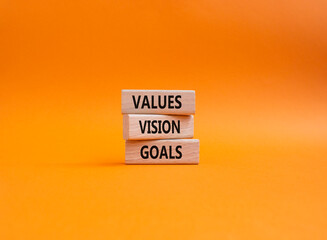 Values Vision Goals symbol. Concept words Values Vision Goals on wooden blocks. Beautiful orange background. Business and Values Vision Goals concept. Copy space.