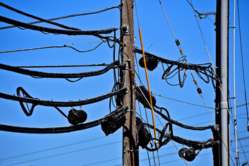 Adding cable and internet services to old neighborhoods cause overcrowded utility poles.