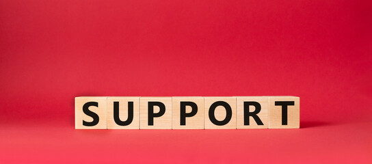 Support symbol. Concept word Support on wooden cubes. Beautiful red background. Business and Support concept. Copy space.