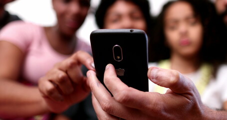 Family gathered together laughing and smiling over social media news