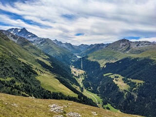 Fototapeta na wymiar Hike in the direction of the col de mille with a view of the Val d'Entremont. Discover Switzerland. Swiss Alps. High quality photo