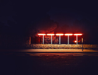 Mystical bus stop at night lit by street lamp. Strangers road. Fairy Forest. Mysterious atmosphere. Paranormal another world. Dark scary park. Background for wallpaper.