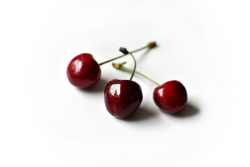 Juicy red ripe cherries on a white background.