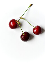 Juicy red ripe cherries on a white background.