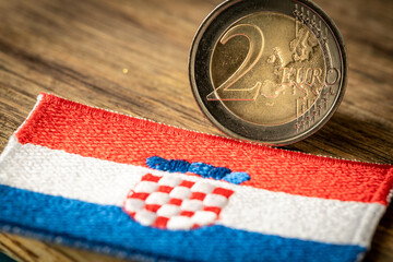 Croatian flag next to the euro coin. Croatia's accession to the Euro zone. Concept, Flag of the Country, Political and economic concept of the European Union - obrazy, fototapety, plakaty