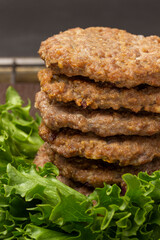 Fried burgers on lettuce leaves. Close up.