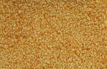 Raw unrefined cane sugar, top view. Brown sugar texture, as background.