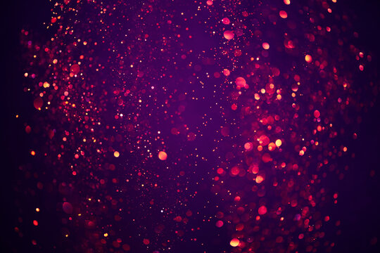 Abstract bokeh background of purple festive shiny glitter lights