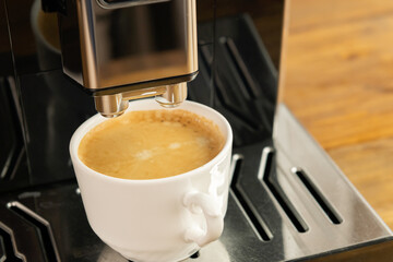 Espresso coffee preparation on a wooden table