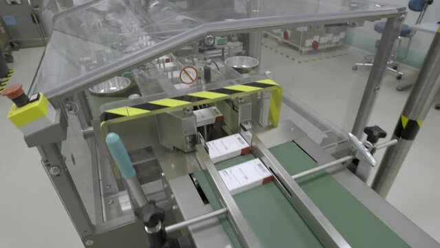 Photo sensor detect medicine bottles on line conveyor in pharmaceutical industry. Industrial Machine for quality of medical product in line conveyor processing. Industrial and technology concept.