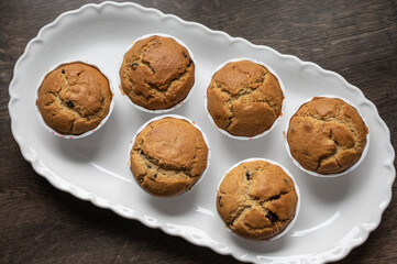 View from above of delicious sweet muffins on white plate