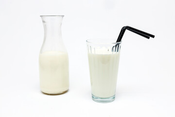 Bottle and Glass of Milk with Black Straws Isolated on White