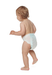 Cute baby in diaper learning to walk on white background