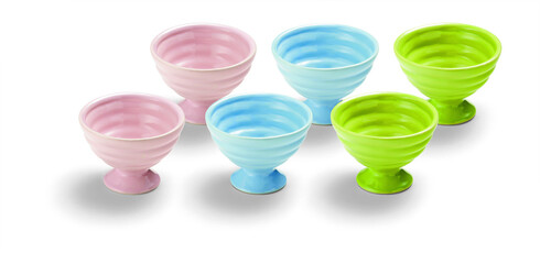 Set of six pink, blue and green grooved empty ceramic ice cream bowls, isolated on white
