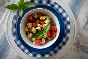 Overhead view of a bowl of caprese salad for a summer lunch