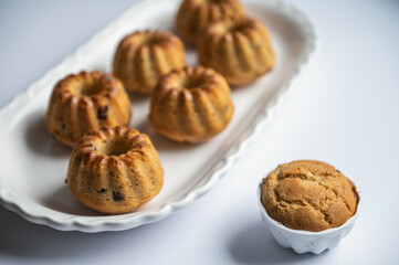 Tasty muffins on nice plate on table at birthday party