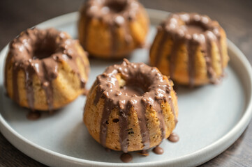 Coating with chocolate glaze muffins at birthday party