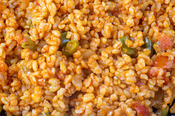Traditional turkish bulgur pilaf with tomato sause in plate (Turkish name; meyhane pilavi)
