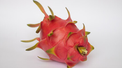 PITAHAYA OR DRAGON FRUIT WITH RED SKIN AND WHITE PULP ON A WHITE BACKGROUND