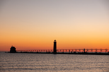 Fototapeta na wymiar Sunset at the Grand Haven, Michigan, lighthouse and pier on Lake Michigan