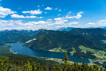 Stunning aerial panorama view of Grundlsee lake from Trisselwand with peaks of Styrian Alps in background on a sunny summer day, Styria, Austria - 516847804