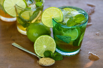 glass of mojito with lime, mint and brown sugar