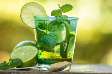 glass of mojito with lime, mint and brown sugar