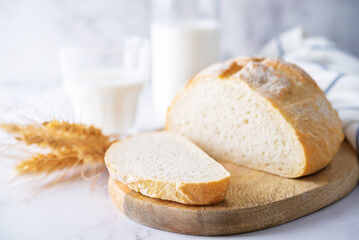 Wheat white bread with glasses of milk