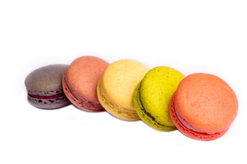 Colorful macaroon cakes. Small french muffins. Colorful macarons on a white background