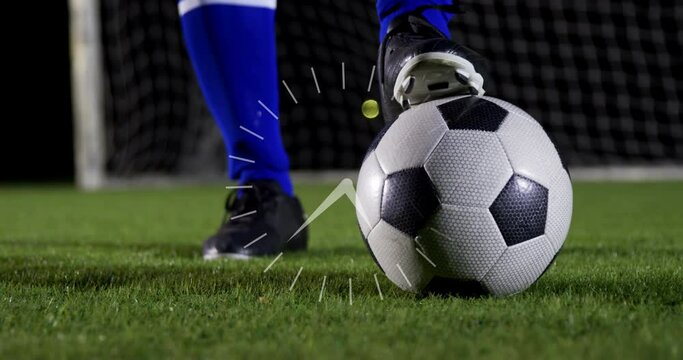 Animation of clock over legs of male soccer player with ball