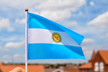 white and blue national flag with sun of Argentina close up