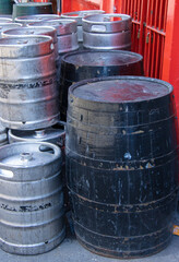 old wooden and new metal beer barrels