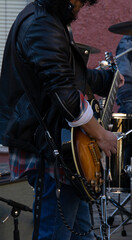 Fototapeta na wymiar street music, unrecognizable man, playing guitar in the street