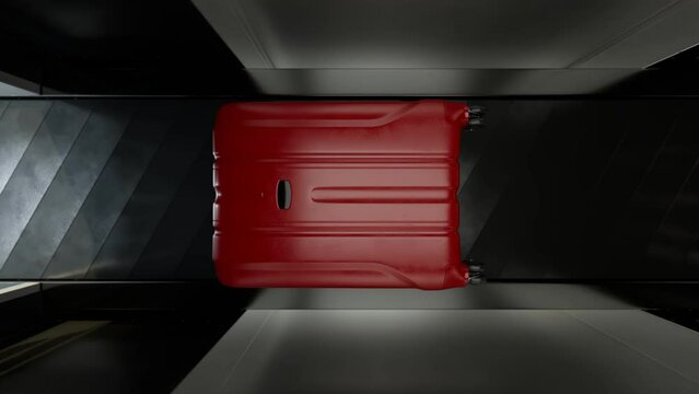 Red suitcase inside an airport scanner on a conveyor belt. Scanning process.
