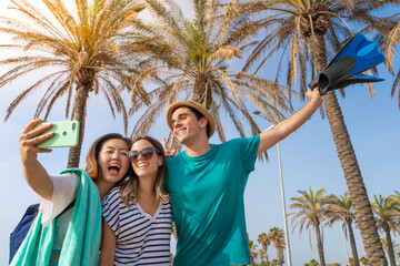 Group of friends taking selfie happy laughing in the beach in summer.