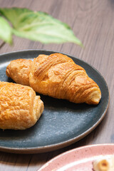 croissant served on modern handmade rustic plate