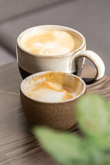 handmade cup with cappuccino coffee served